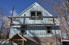 Home being insulated to increase performance and decrease heat loss